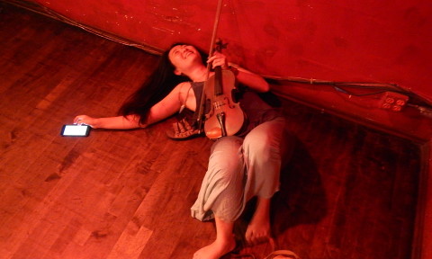 Jamie Shadowlight lays on the floor in the Europa Cafe.